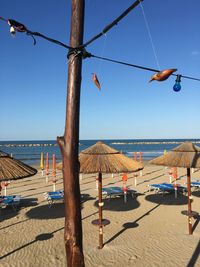 Clothes hanging on beach against clear blue sky