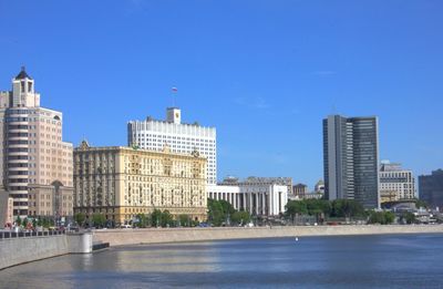 Buildings in city against blue sky