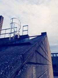 Low angle view of built structure against cloudy sky