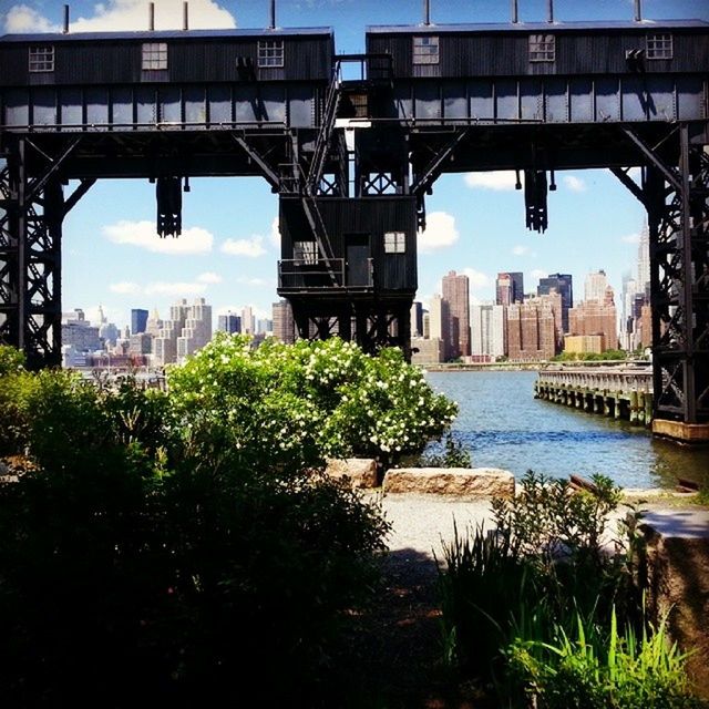 architecture, built structure, building exterior, bridge - man made structure, connection, water, city, river, sky, bridge, engineering, cityscape, transportation, waterfront, tree, no people, growth, reflection, tower, outdoors