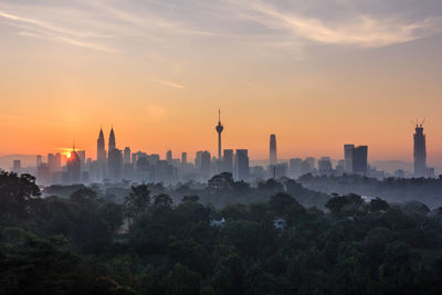 View of buildings in city during sunset