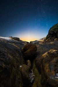 Rock formations against sky at night