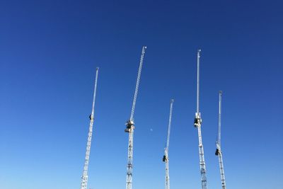 Low angle view of crane against clear sky