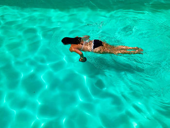 High angle view of woman swimming in pool