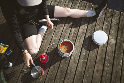 Woman preparing food at lake