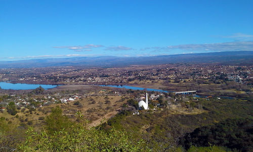 Aerial view of cityscape against clear blue sky
