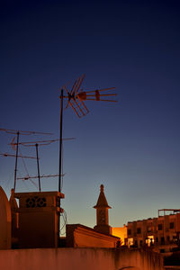 Antennas on a rooftop in the golden light of nightfall