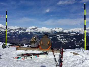 People skiing on snowcapped mountain against sky