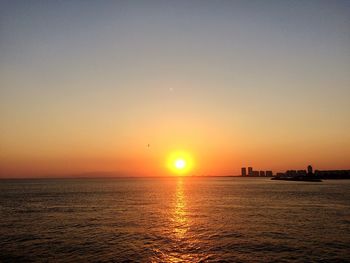 Scenic view of sea against orange sky