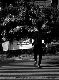 Rear view of man walking on street