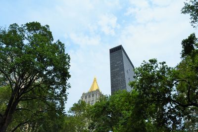 Low angle view of buildings against cloudy sky