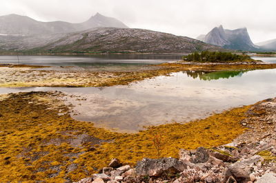 Scenic view of lake and mountains against sky