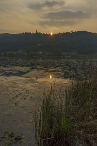 Scenic view of lake against sky during sunset