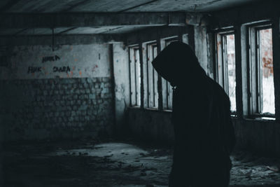 Dog standing in abandoned building