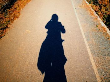 Shadow of people on road