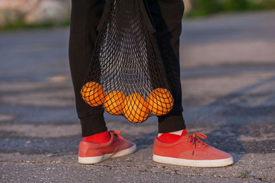 Low section of woman with oranges