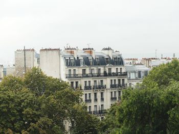 Buildings in city against clear sky