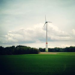Windmill on field against sky
