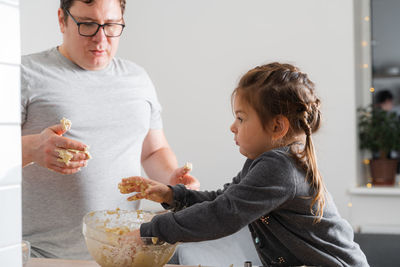 Mother and daughter eating food at home