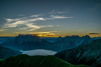 Scenic view of snowcapped mountains against sky during sunset