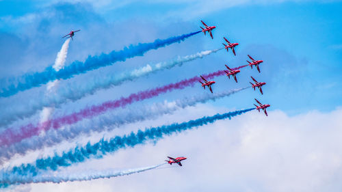 Low angle view of airshow against sky