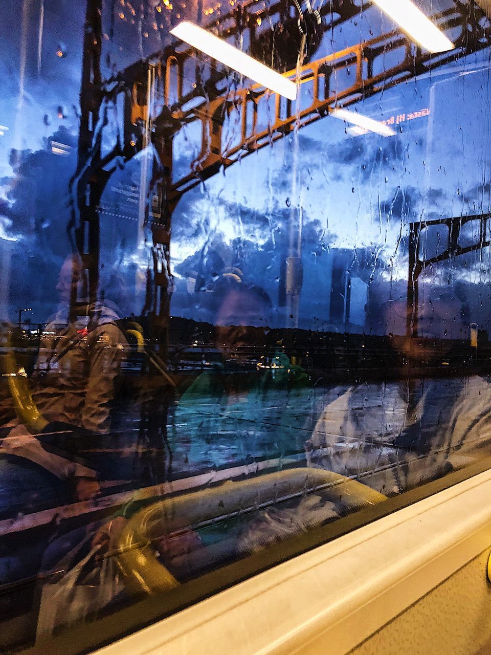 REFLECTION OF WOMAN ON CAR WINDOW