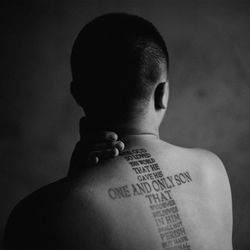 Rear view of shirtless man with text