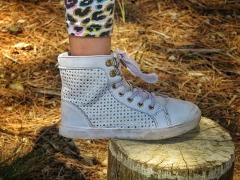 Low section of woman standing on field