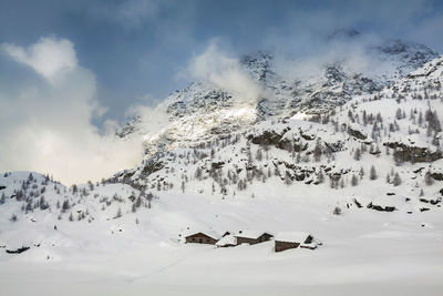 Aerial view of snow covered mountains against sky