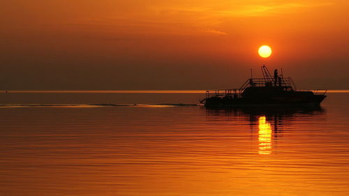 Romantic sunset at lake balaton with ship