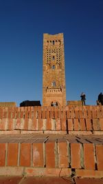 Low angle view of historical building against clear blue sky