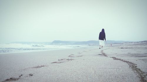 Silhouette of woman standing on beach