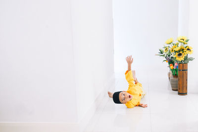 Boy in traditional clothing lying on floor