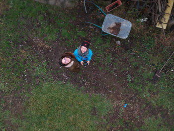 High angle view of father and daughter on grass
