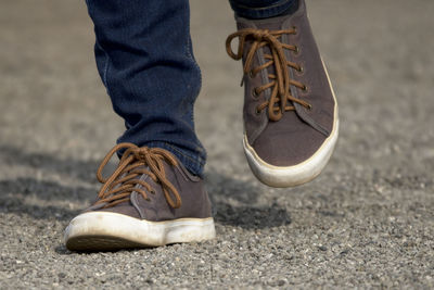 Low section of man standing on street