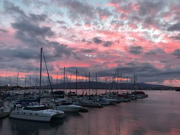 Boats in harbor at sunset