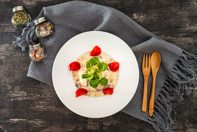 Directly above shot of food served in plate on wooden table