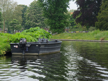 Boat in river against trees