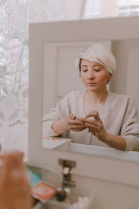 Portrait of a beautiful young woman sitting at home