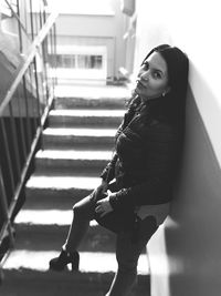 Portrait of woman sitting on staircase