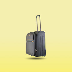 Brown luggage isolated on yellow pastel background.