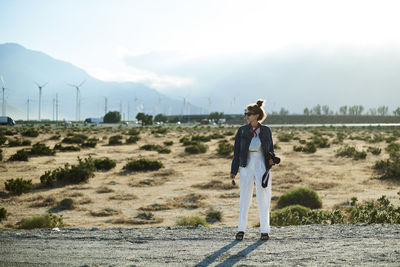 Full length of man standing on land against sky