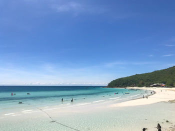 Scenic view of beach against blue sky