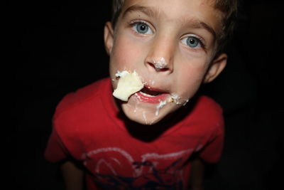 Close-up of boy with food on his face