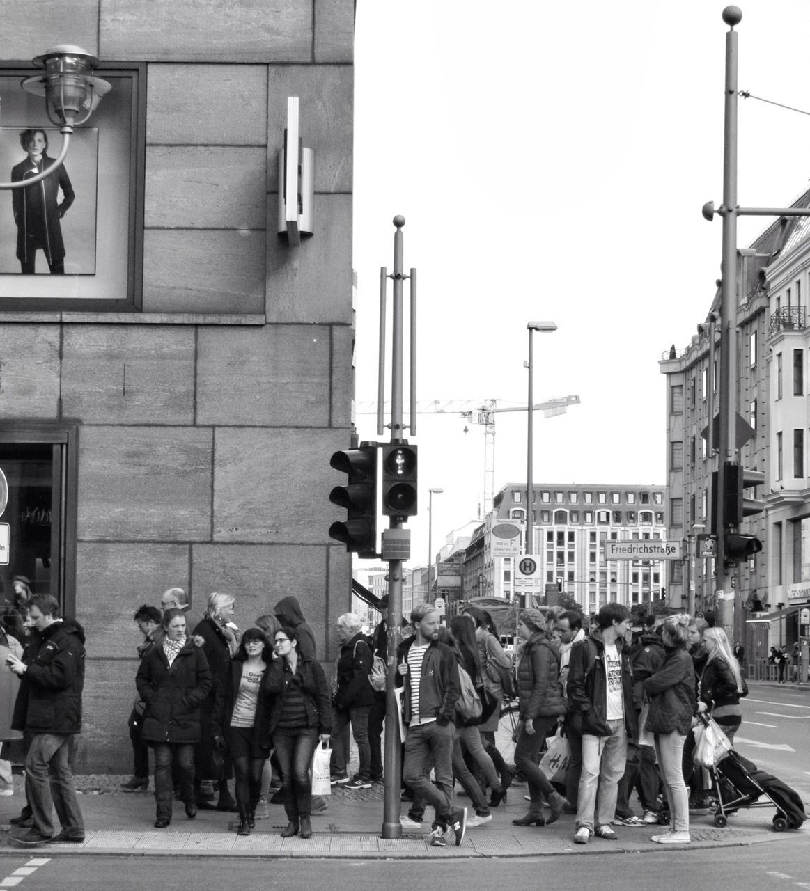 large group of people, building exterior, men, architecture, person, built structure, lifestyles, street, walking, city, city life, leisure activity, mixed age range, crowd, clear sky, day, city street, outdoors, building