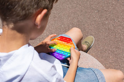 Rear view of boy holding toy