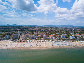 Aerial view of town by buildings in city against sky