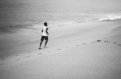 Full length of woman standing on beach