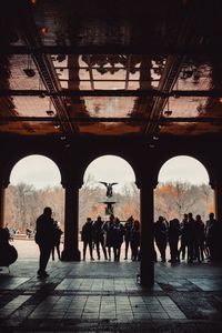 Group of people walking in historic building