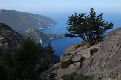 High angle view of rocks by sea against sky